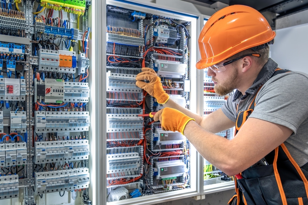 Electrician working on electrical wiring and installation